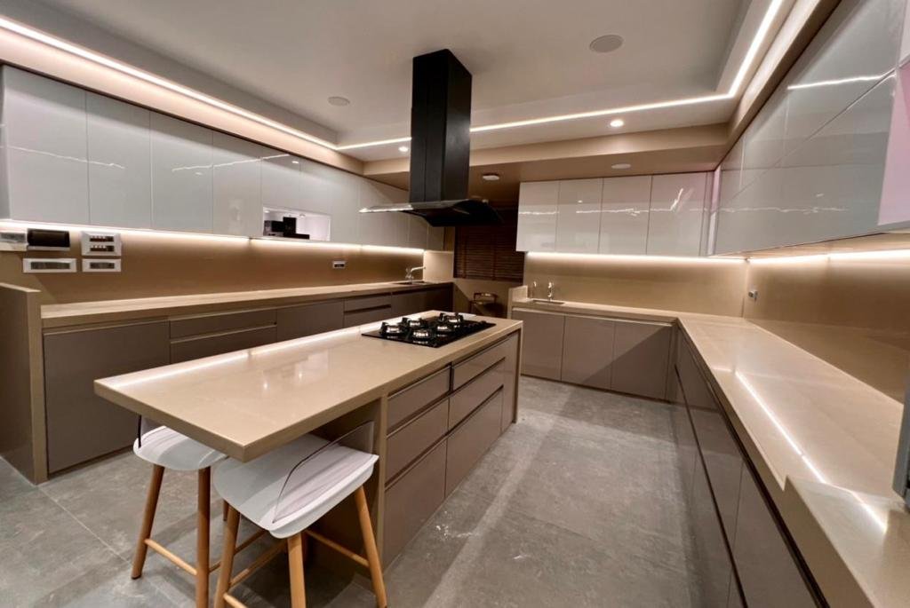 Modern island kitchen with dark chimney hood